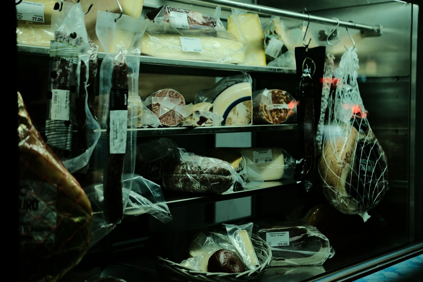 Deli cheese and charcuterie counter at a food market