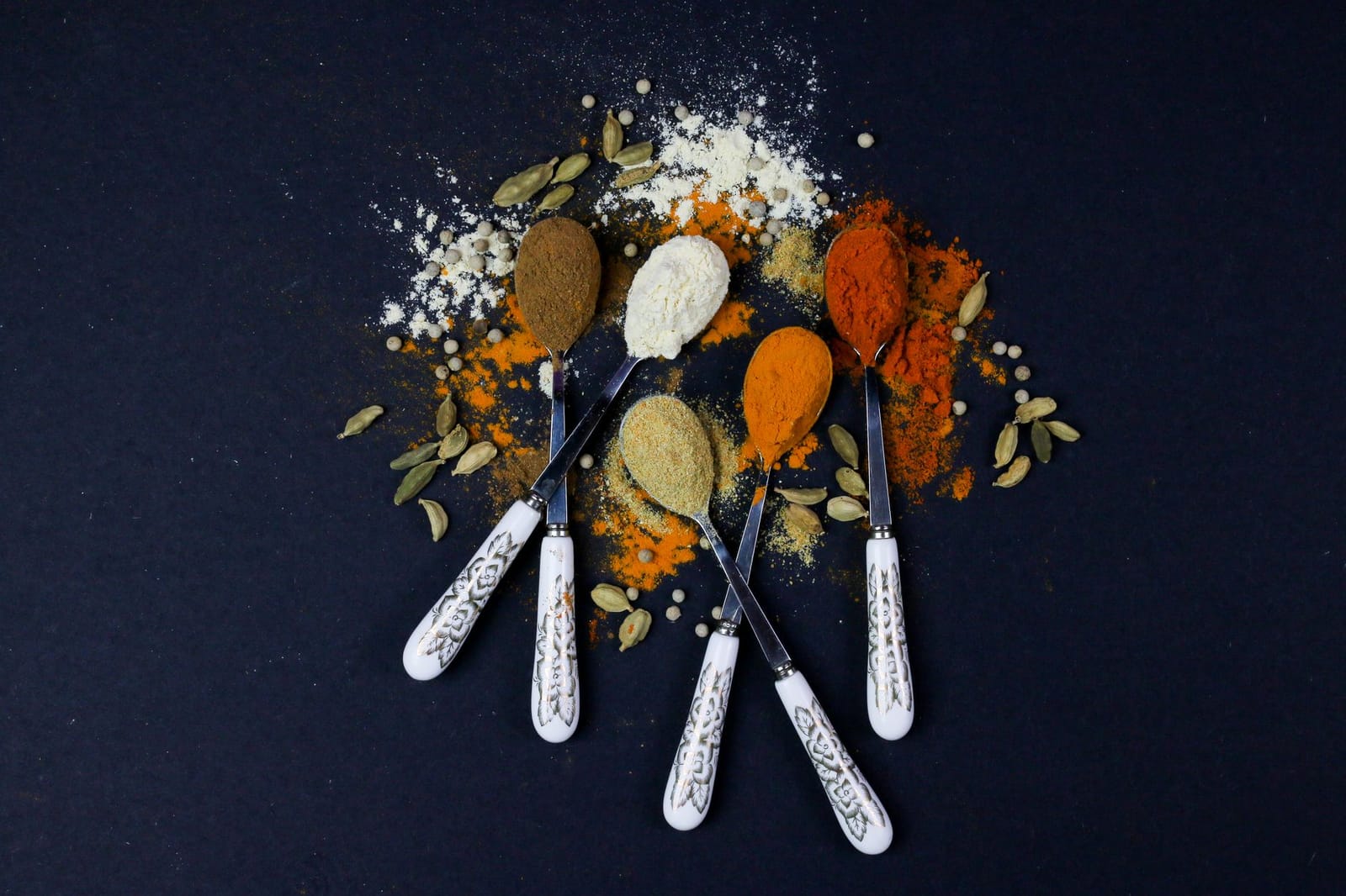 Ground cardamom powder on a spoon