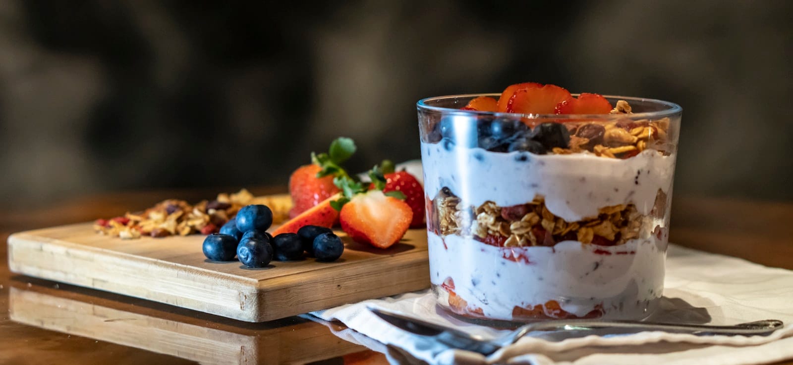 Granola served over coconut yoghurt and berries