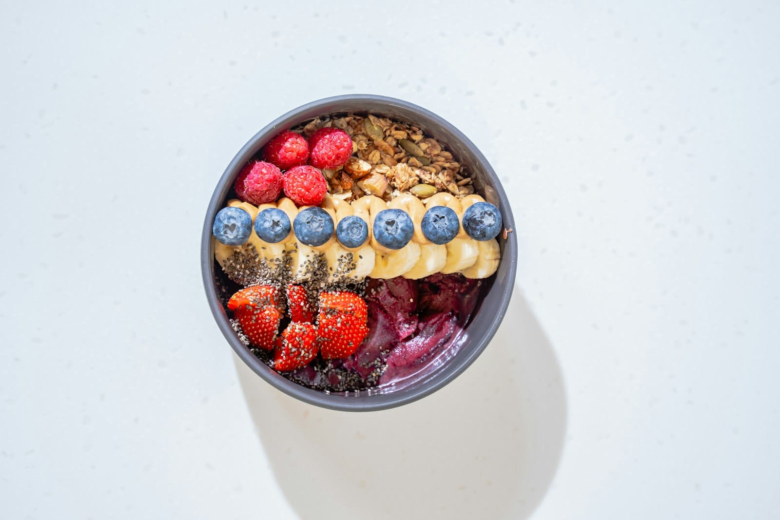 A homemade acai bowl topped with fresh fruit