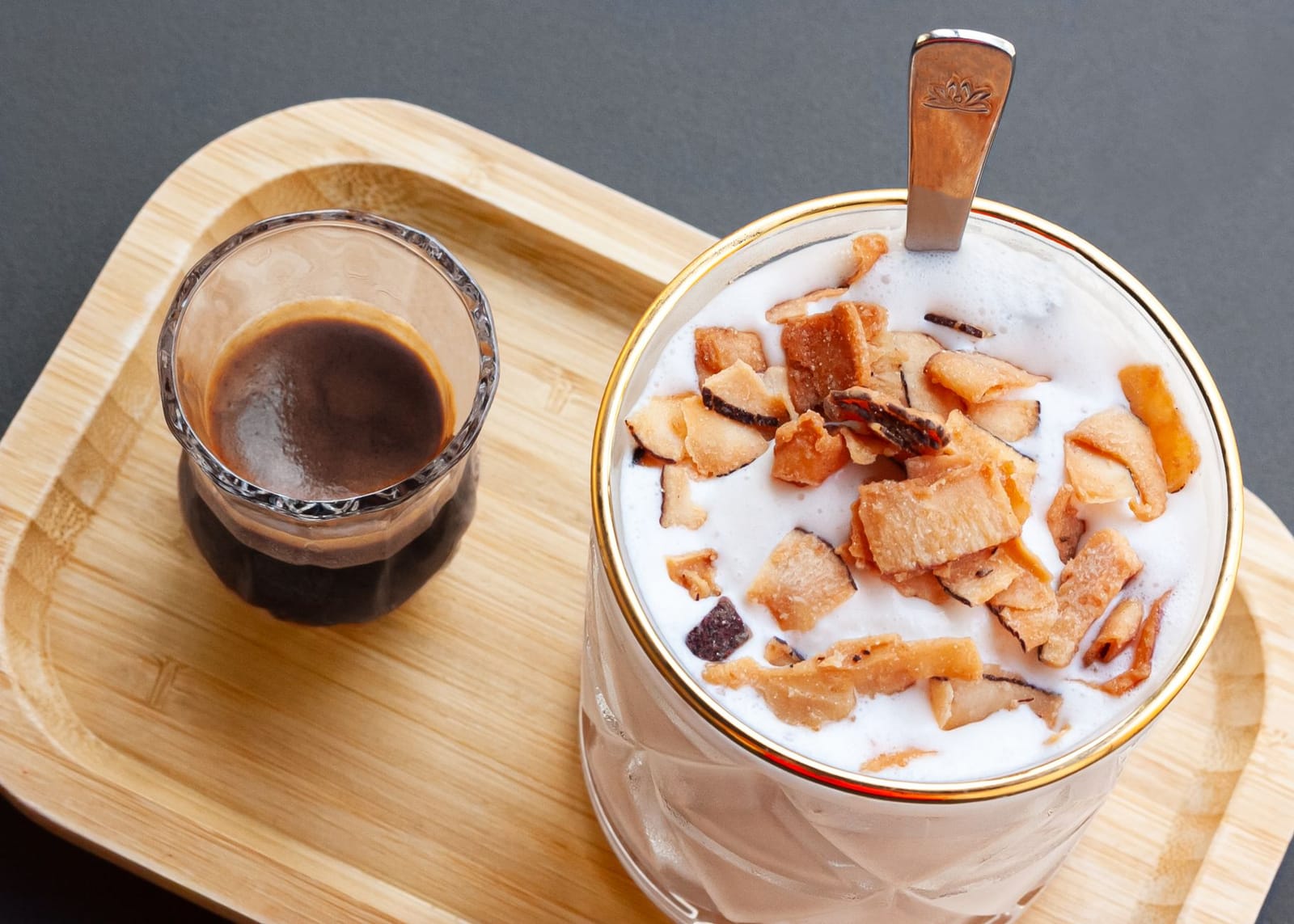 Coconut milk in a glass beside fresh coconut
