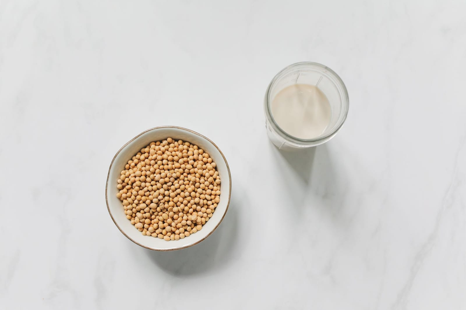 Soy milk in a glass with soybeans