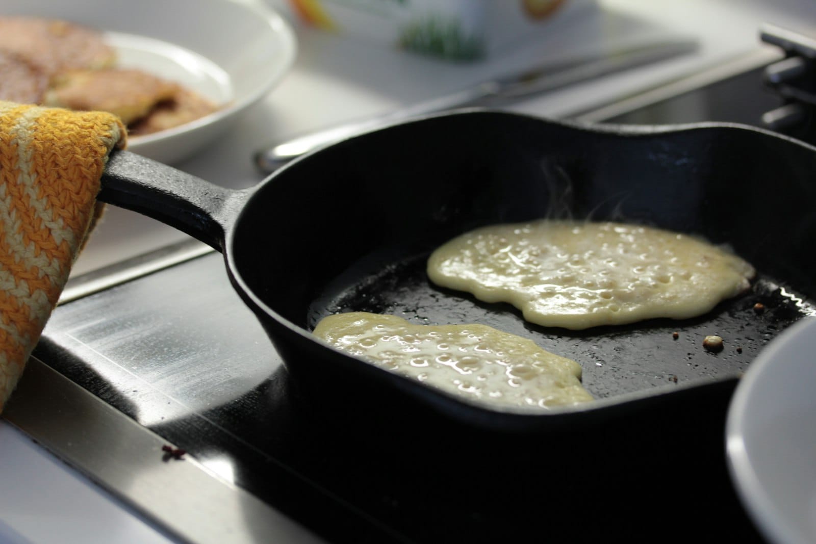 Pancakes cooking in a frying pan