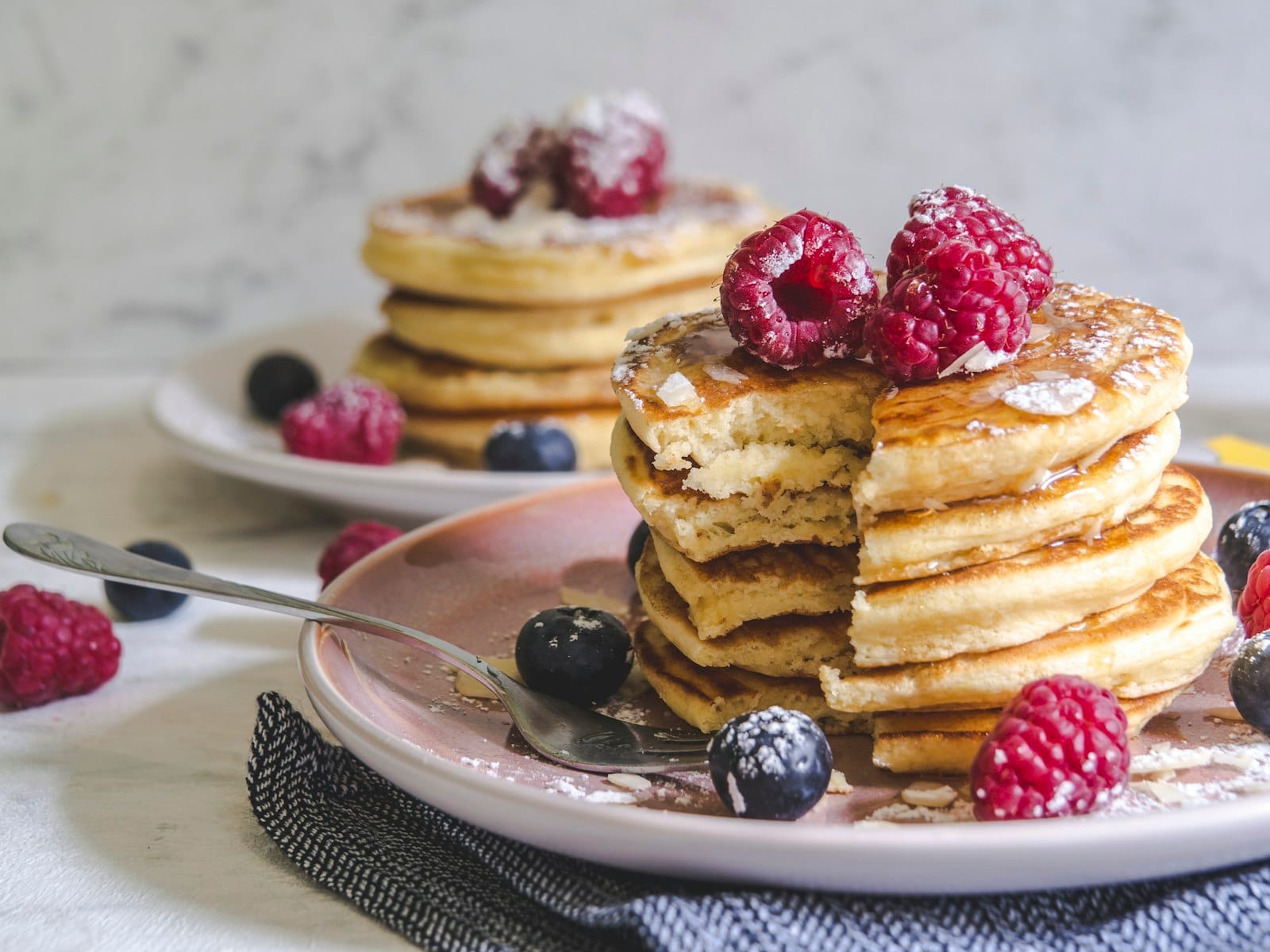Vegan pancakes plated with fresh berries