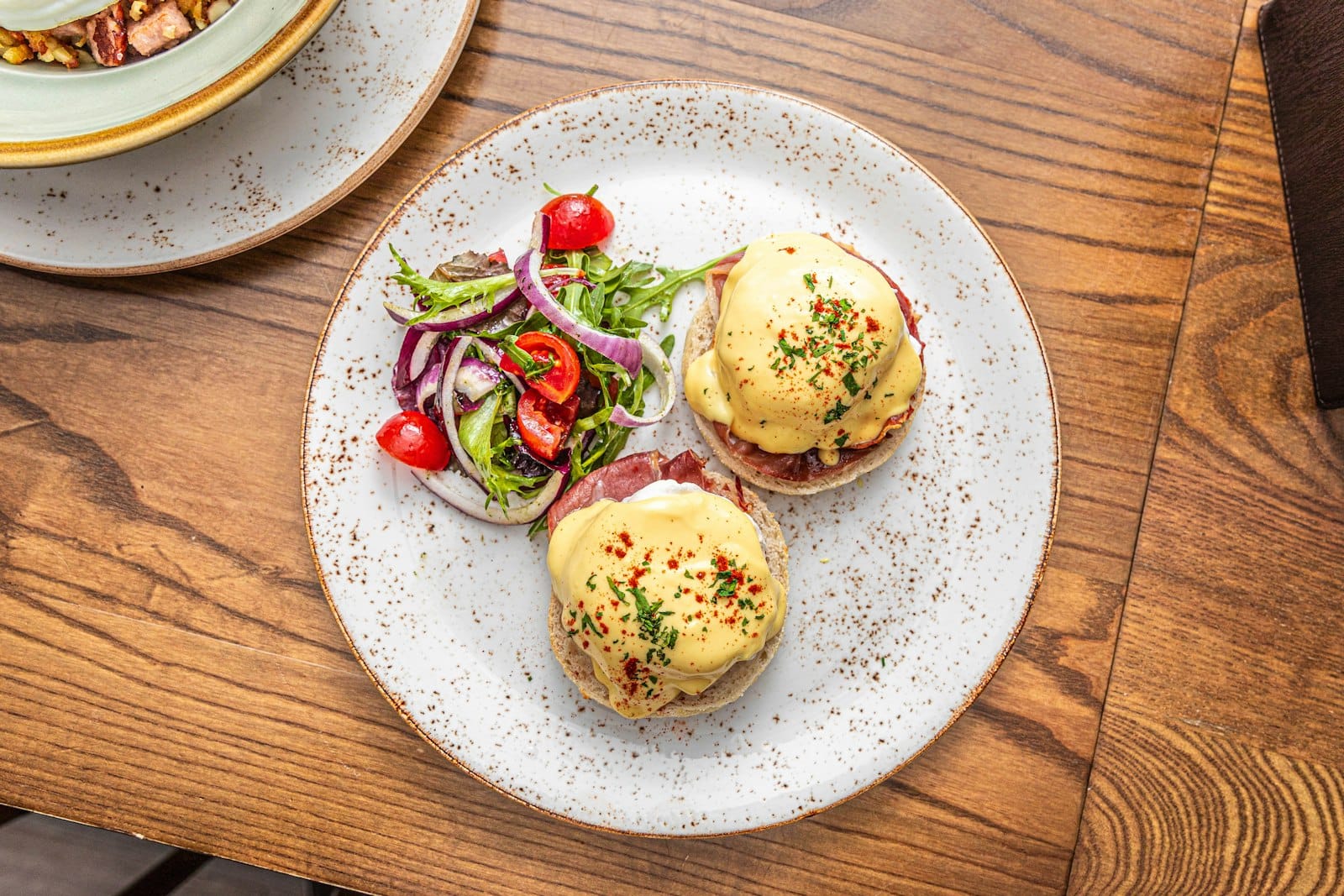 Brunch plate with hollandaise, greens and toast