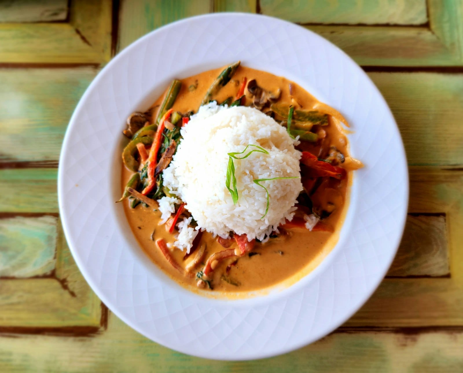 Vegan curry served with rice and fresh herbs