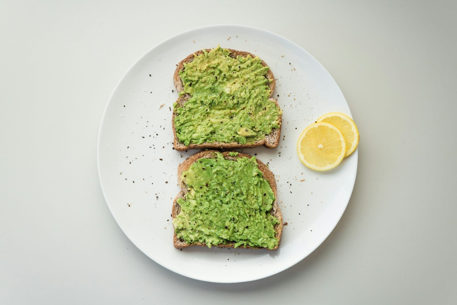 Vegan smashed avocado on sourdough toast with tomatoes and seeds