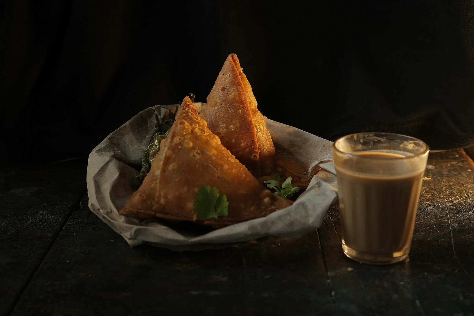 Freshly made samosas and Indian sides on a plate