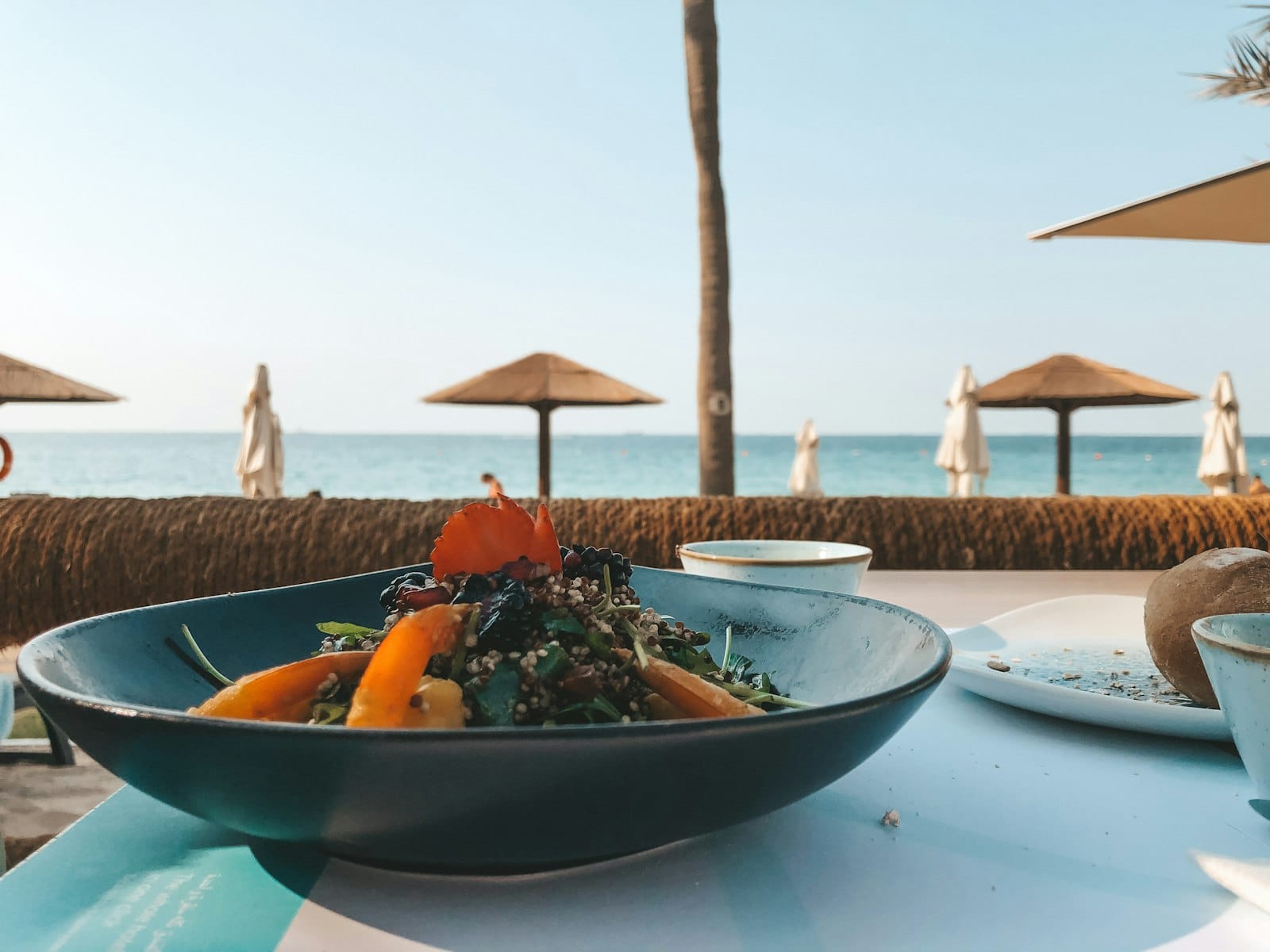 An acai bowl on a beachside table