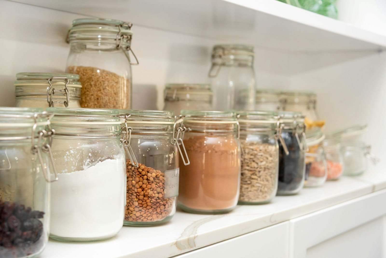 Pantry staples of grains and legumes in jars