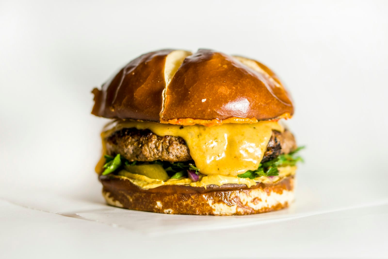 A close-up of melted cheese on a burger