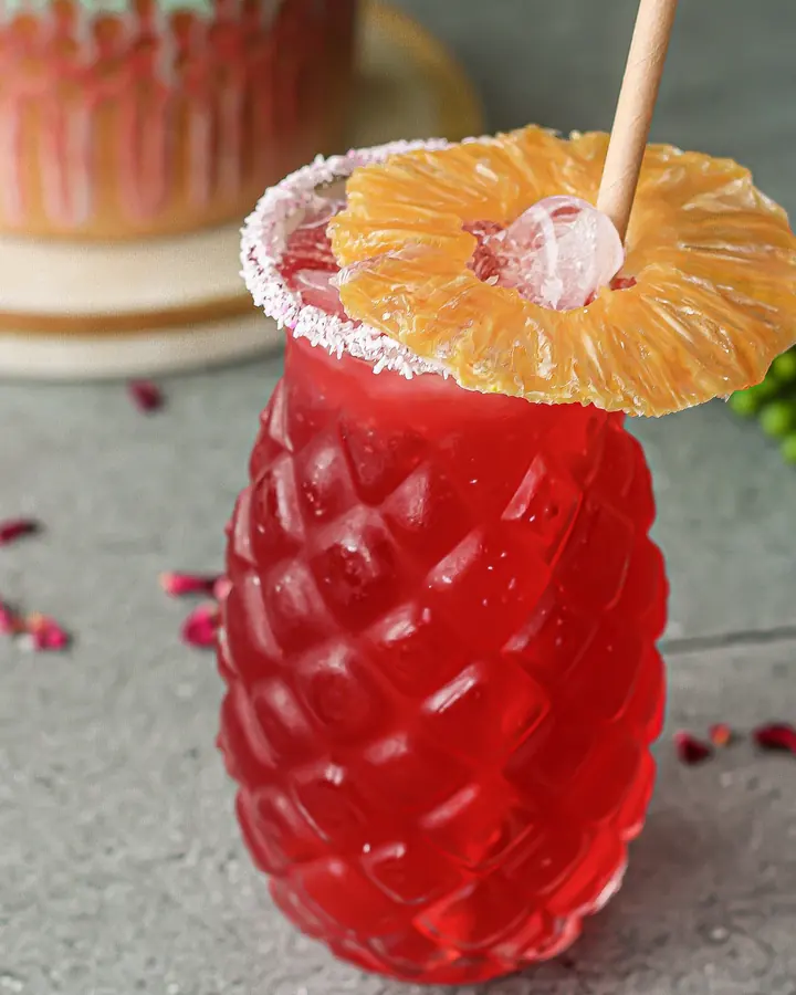 A freshly made fruit cooler served over ice with pineapple