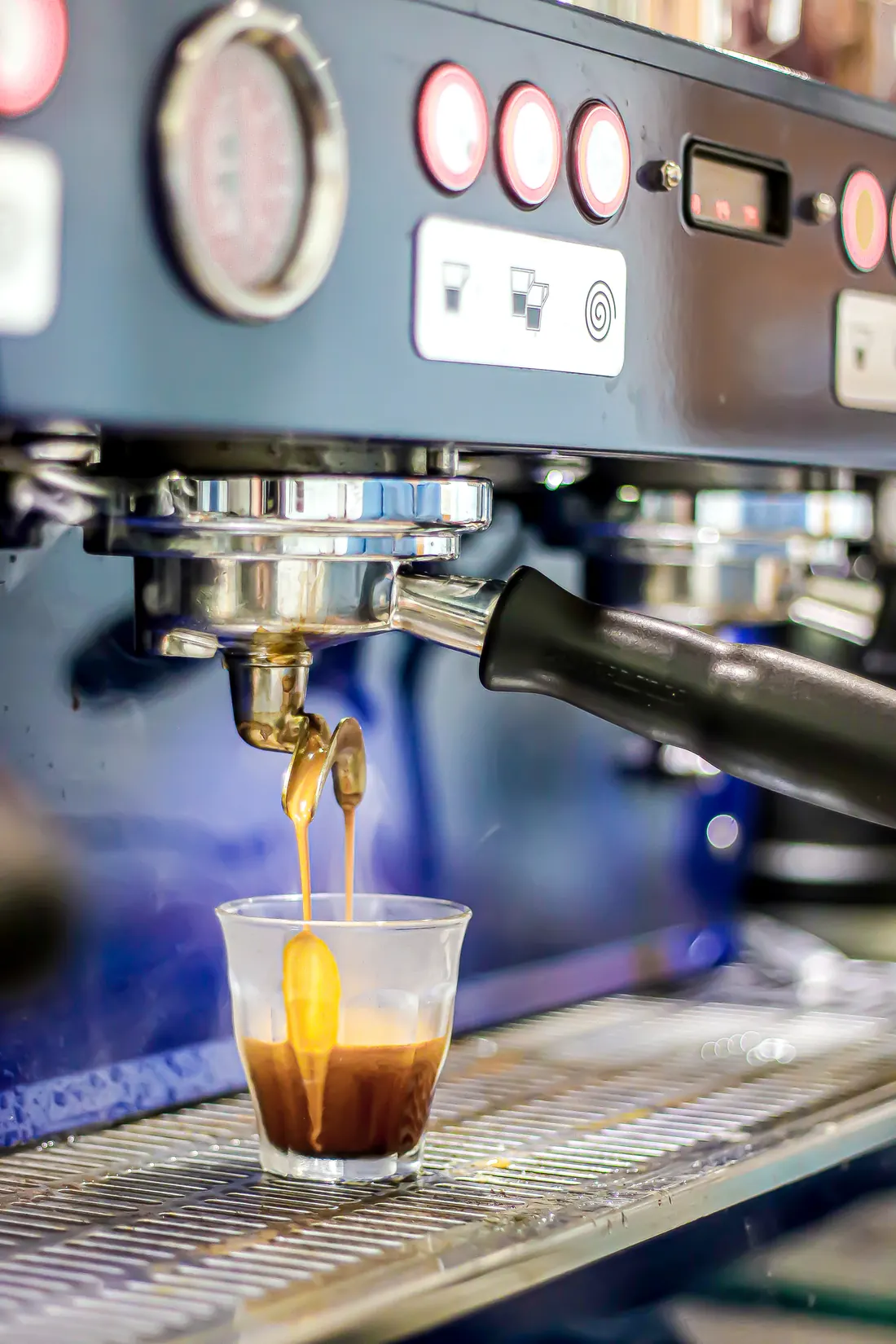 Espresso pouring into a glass at The Cardamom Pod on a slow morning