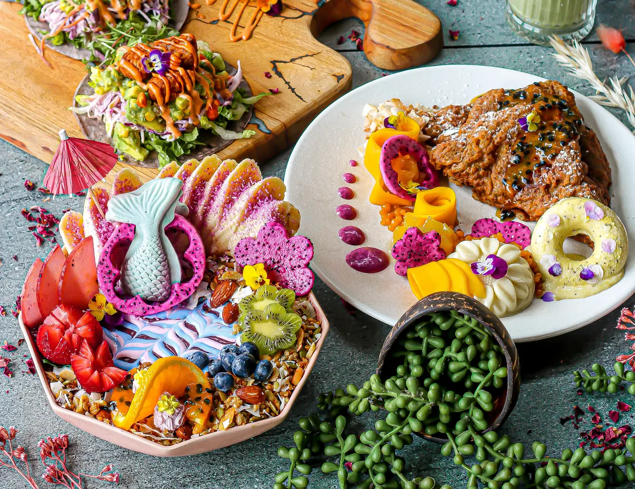A shared table of colourful plant-based dishes at The Cardamom Pod