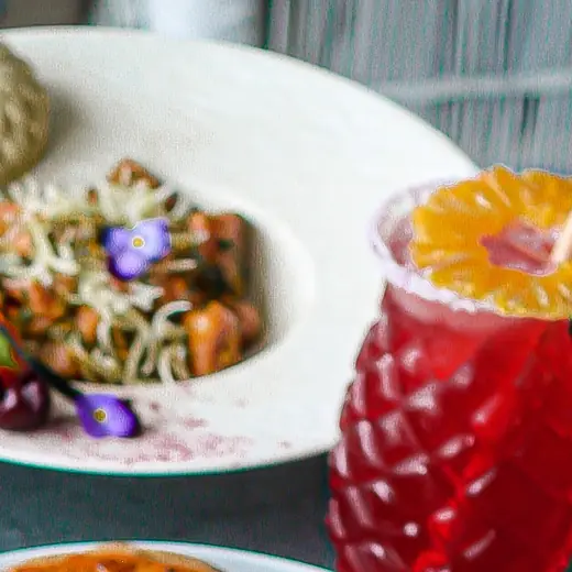 A plated dumpling and rice dish scattered with edible flowers
