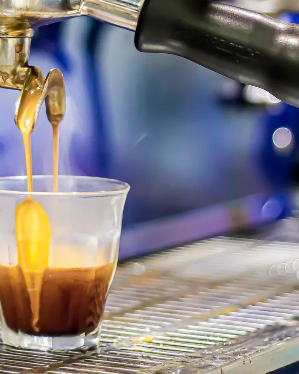 A close-up of espresso filling a glass