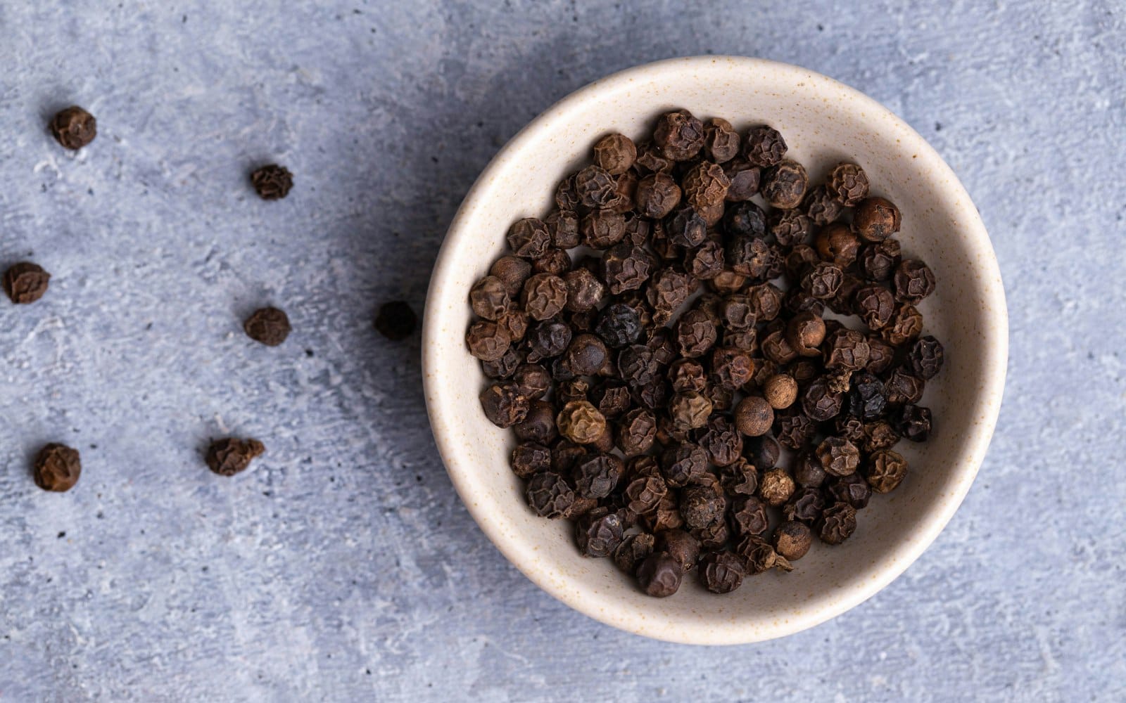 A close-up of black pepper spice