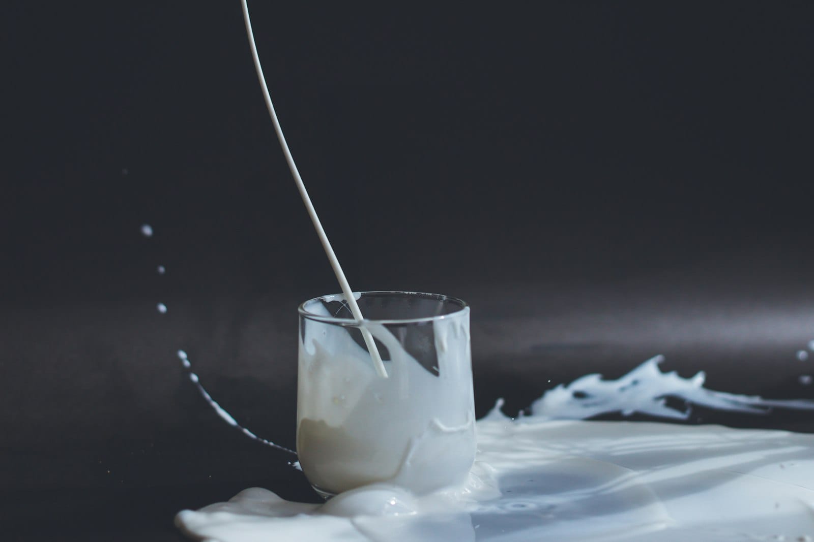 Pouring warm milk into a cup