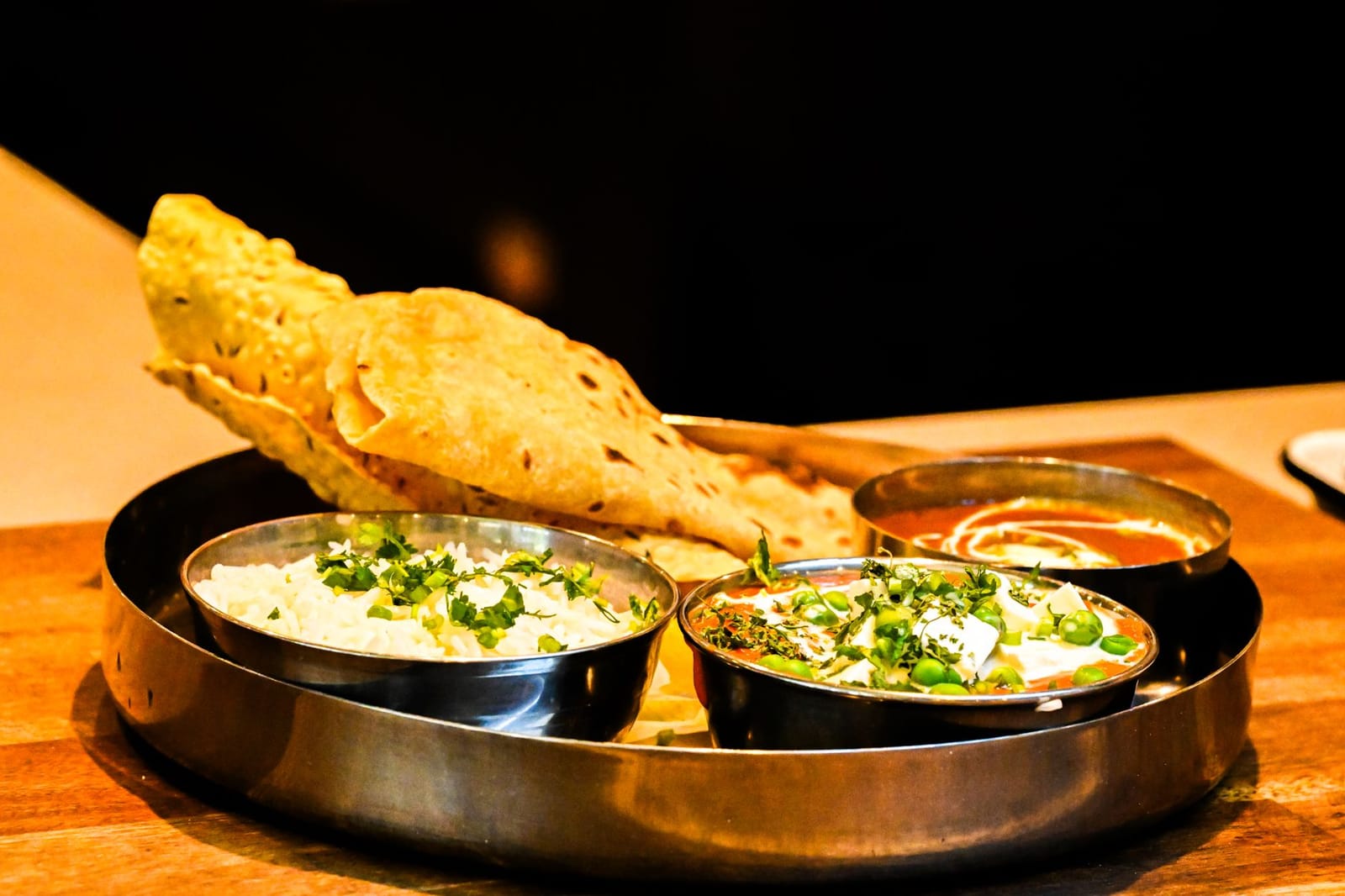 An Indian thali plate with multiple dishes