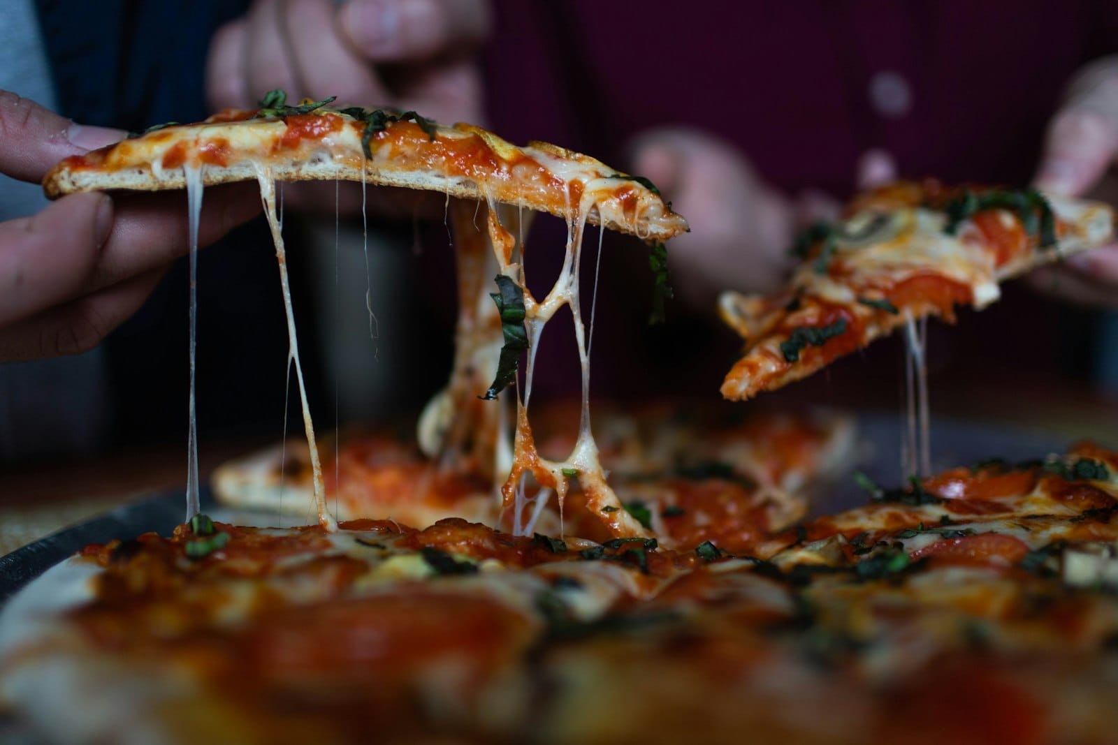 A pizza slice with melted vegan cheese