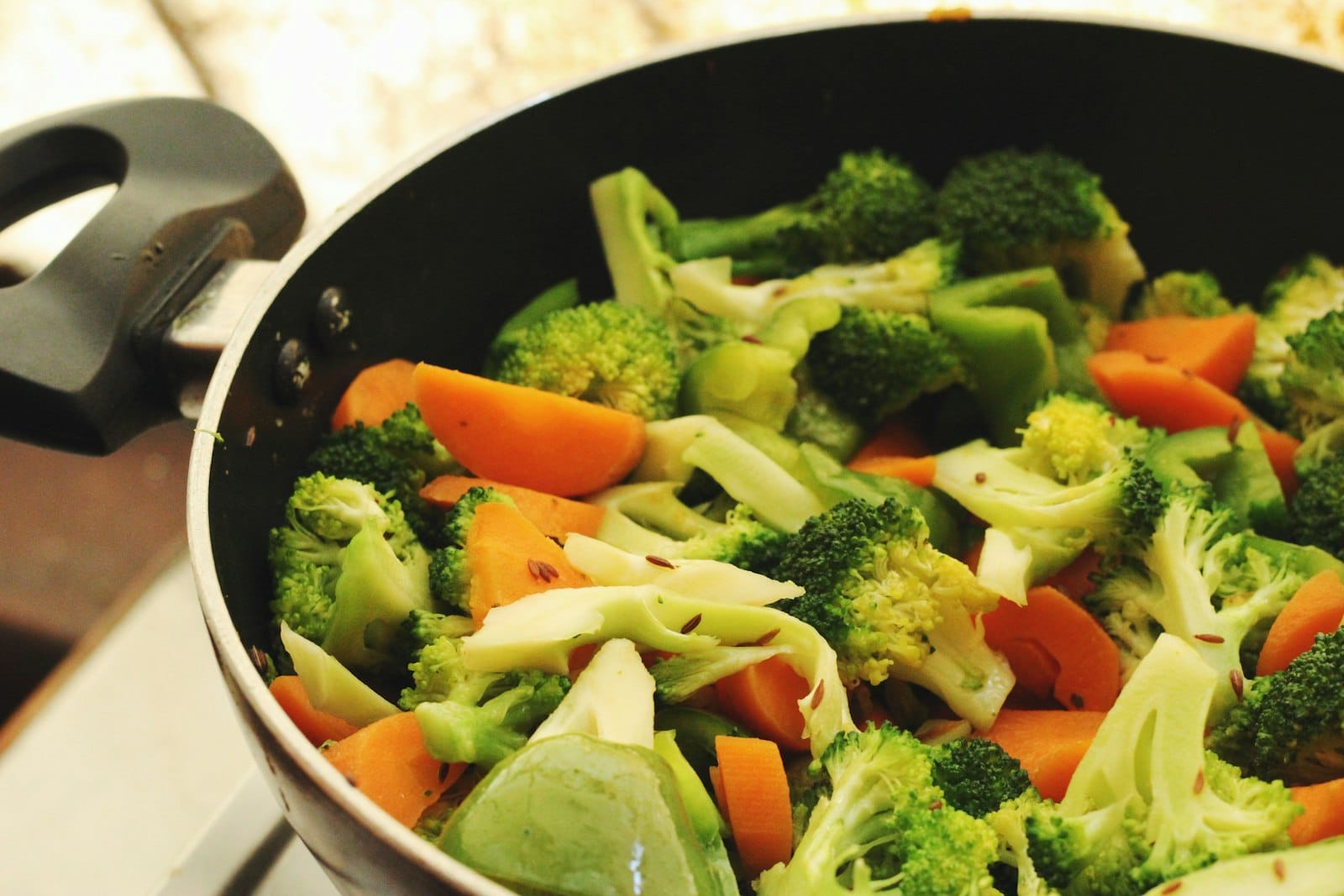 A stock pot simmering with vegetables